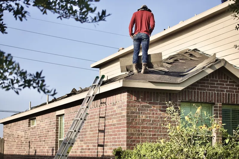 Professional roofer working on a residential roof in East Brooklyn